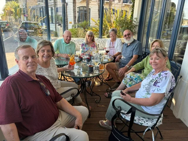 Friends sharing drinks on a sunny terrace