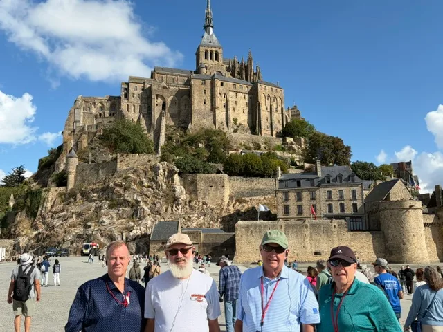 Four friends in front of Mont-Saint-Michel