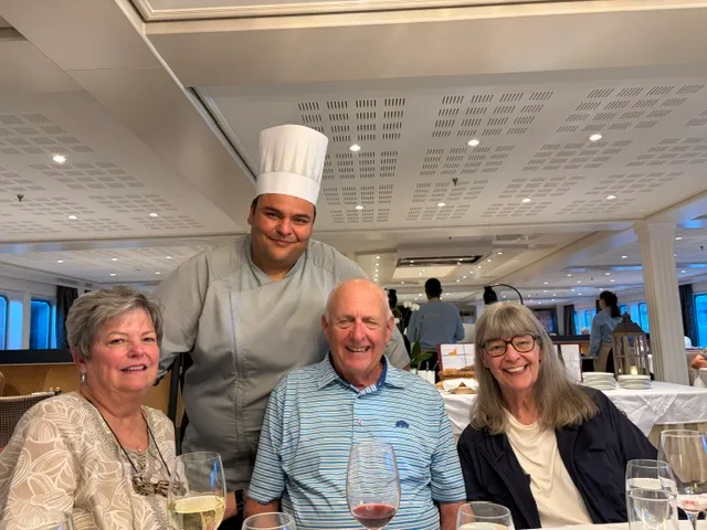 A couple with the ship's chef in the dining room