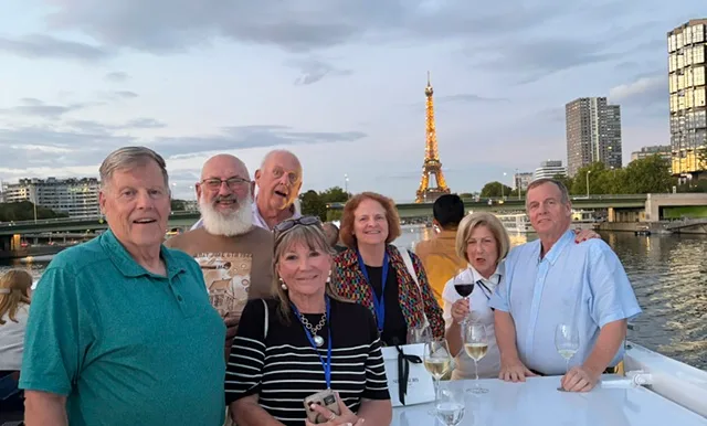 Friends on the sun deck with the Eiffel Tower behind them