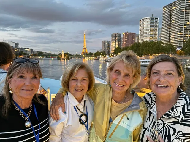 Four friends on deck as the lights come on in Paris