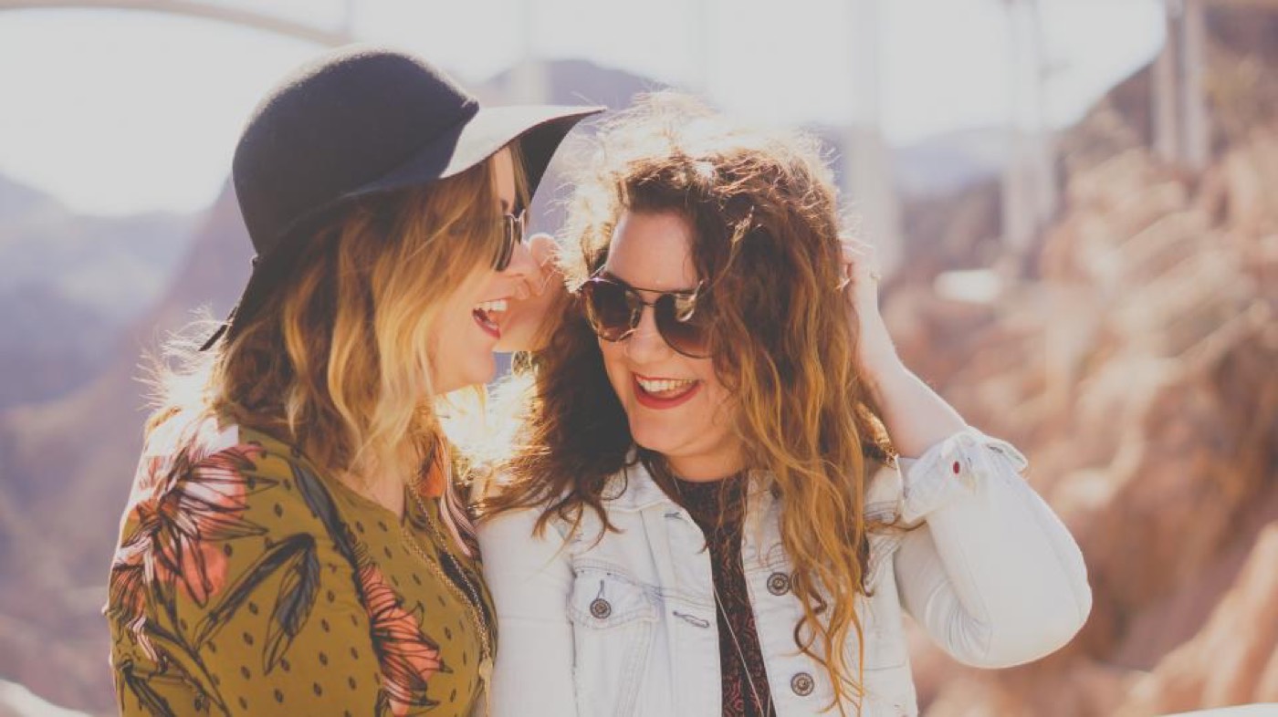 Two women laughing on a trip
